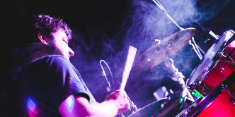 Un Juanito feliz dándole a los tambores.